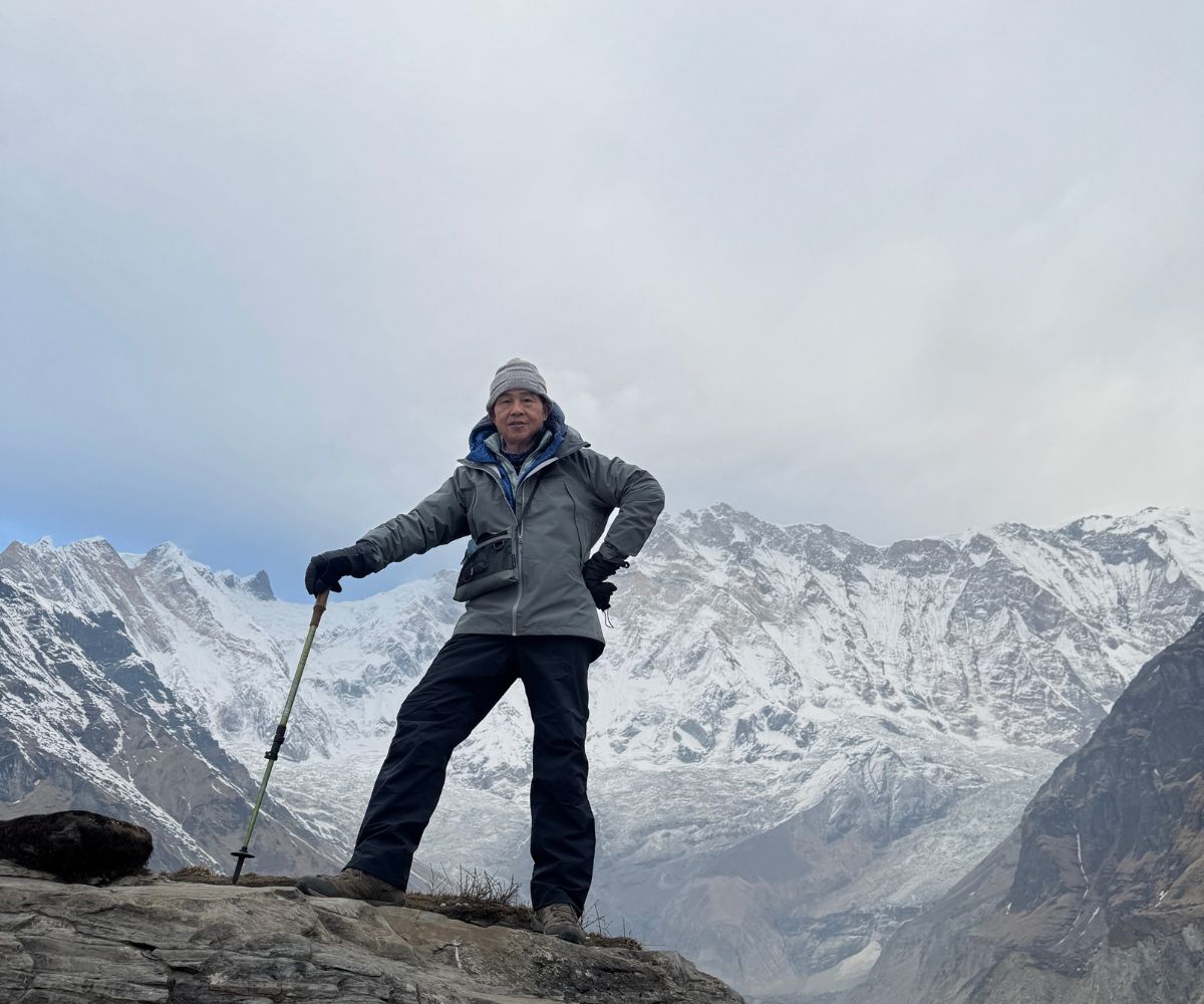 Solo Trekker Standing In Front Of Mount Annapurna